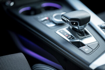Car interior with purple light, steel and leather. Product photography. Soft background. - obrazy, fototapety, plakaty
