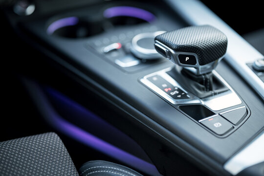 Car interior with purple light, steel and leather. Product photography. Soft background.