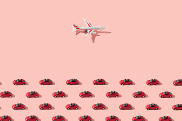 Different transportation vehicles, red cars and airplane against bright pink background. Minimal...