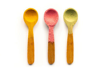 Healthy Eating Concept with Different Colorful Superfood Powders in Wooden Spoons on White Background. Turmeric, Strawberry and Matcha Powder. Vegetarian and Vegan Diet