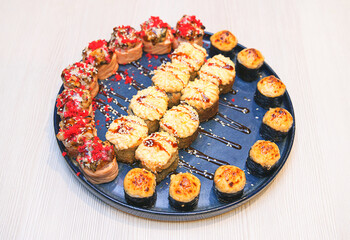 Set of different baked rolls on a plate, selective focus, national Japanese food