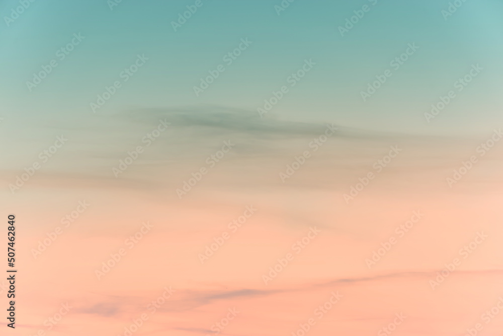 Wall mural sunset background. sky with soft and blur pastel colored clouds. gradient cloud on the beach resort.