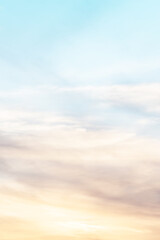 Obraz premium Vertical ratio size of sunset background. sky with soft and blur pastel colored clouds. gradient cloud on the beach resort. nature. sunrise. peaceful morning. Instagram toned style
