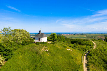 Fototapeta na wymiar Aerial view from nature reserve the little Kalmit. Is located in the east of the Palatinate Forest near the wine and holiday resort of Ilbesheim. A small chapel on the hilltop. Rhineland-Palatinate.