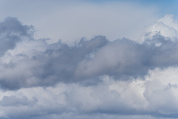 Gray overcast cloudy sky over horizon. Closeup clouds