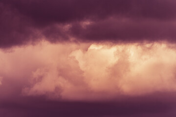 Twilight sky with effect of light pastel orange colors. Colorful sunset of soft clouds.