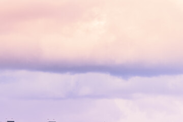 Twilight sky with effect of light pastel pink colors. Colorful sunset of soft clouds.