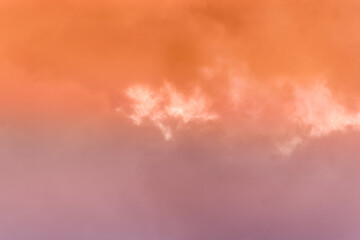 Naklejka na ściany i meble Twilight sky with effect of light pastel orange colors. Colorful sunset of soft clouds.