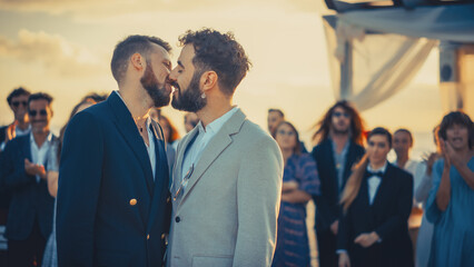 Portrait of a Happy Just Married Handsome Gay Couple Kissing, Showing Off Their Gold Wedding Rings....