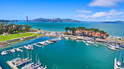 Aerial view of yacht harbor in San Francisco with Golden Gate Bridge in distance