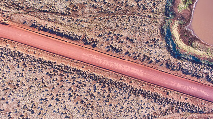 Aerial of red dirt road in desert plains
