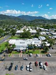 Vertical aerial view of tropical city, shopping centre and mountains in Cairns