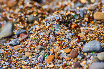 Detail of beach filled with colorful and shiny glass pieces
