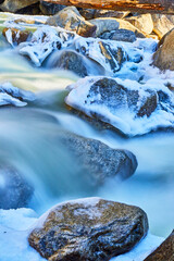 Frosty rocks with water cascading over them in Yosemite
