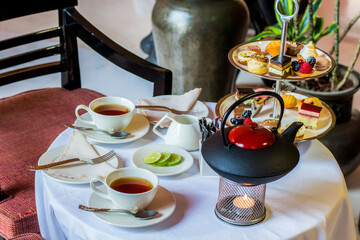 Tea table with desserts, Photo is selective focus with shallow depth of field.