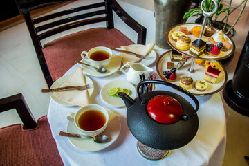 Tea table with desserts, Photo is selective focus with shallow depth of field.