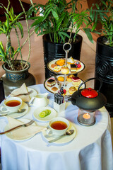 Tea table with desserts, Photo is selective focus with shallow depth of field.
