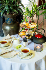 Tea table with desserts, Photo is selective focus with shallow depth of field.