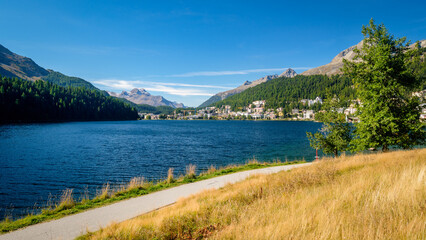 Lake St. Moritz (Grisons, Switzerland) on a sunny autumn morning. It is smaller than the main lakes of the Upper Engadine Valley (Sils and Silvaplana). Polo matches are held on the lake if it's frozen
