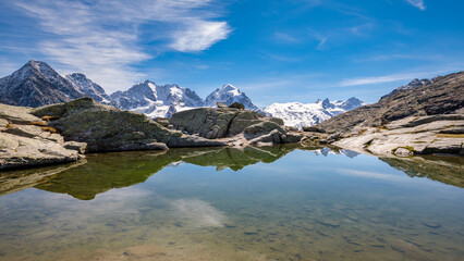 Fuorcla Surlej is a mountain pass in the Swiss Alp (connecting the Upper Engadine Valley with Roseg Valley) with stunning views on the Bernina Massif. There is also a small lake and a mountain hut.