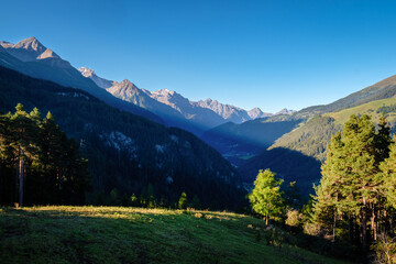 The sun is rising on a autumn morning at mountain pass Norbertshöhe (Tyrol, Austria), that offers a gorgeous view into the Swiss Lower Engadine Valley. It's near the Austria-Switzerland border.