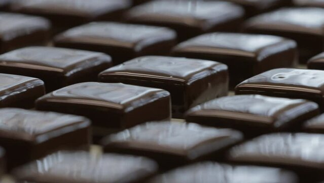 Chocolates without wrappers that have passed all the stages of preparation and are waiting to be sent for packaging.