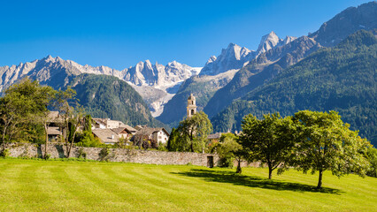 Nice autumn view on the gorgeous village of Soglio, located on the mountainside on the northern side of the Val Bregaglia (Grisons, Switzerland). Val Bondasca and its glacier can also be seen. 
