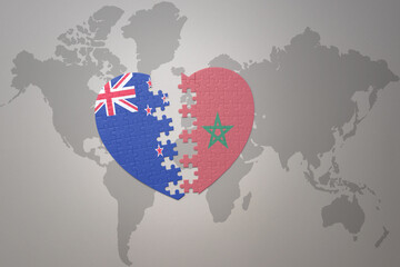 puzzle heart with the national flag of new zealand and morocco on a world map background. Concept.