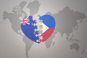 puzzle heart with the national flag of new zealand and philippines on a world map background. Concept.