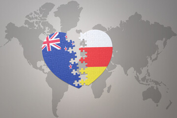 puzzle heart with the national flag of new zealand and south ossetia on a world map background. Concept.