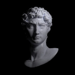 Light and shade dramatic illustration from 3d rendering of classical white marble male head bust looking straight and illuminated by a theatrical light source.