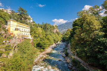 Fototapeta na wymiar Merano (or Meran) is a city surrounded by mountains near Passeier Valley and Val Venosta (South Tyrol, Italy). The Passer river flows through Merano. It's a popular among famous artists and scientists