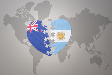 puzzle heart with the national flag of new zealand and argentina on a world map background. Concept.