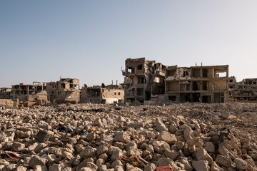 residential building ruins in destroyed city after war