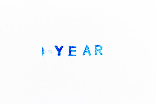 Blue color ink of rubber stamp in word year on white paper background