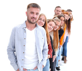 Fototapeta premium handsome guy standing in front of a group of young people