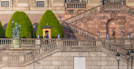 The parterre Logården at the royal castle with stairs and guard a sunny day in Stockholm