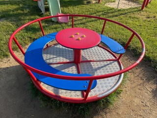 Red and blue children's carousel on a campsite in East Germany
