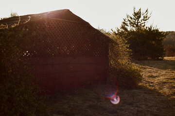 The exterior of the gazebo on in the rays of the sun at sunset.