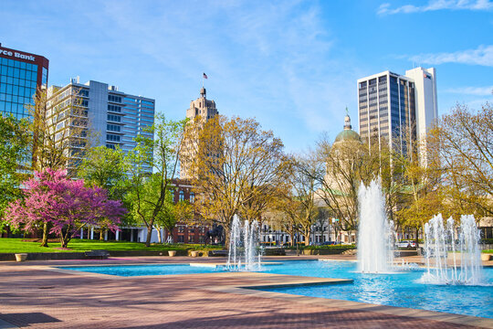 Freimann Square park in downtown Fort Wayne in spring with cherry tree, fountains and courthouse