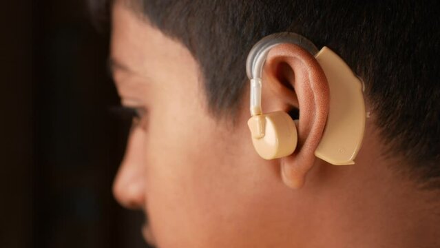 Hearing aid concept, teenage boy with hearing problems.
