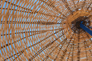 Bottom View Of Wicker Umbrella at Beach. Vacation or Holiday Concept and Ideas. 
