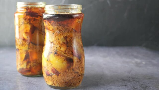 Homemade Mango Pickle in a glass jar on table ,