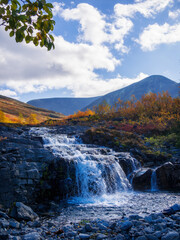 Beautiful mountain waterfall among rocks in polar summer in Khibiny Mountains. Kola Peninsula, Arctic, polar summer