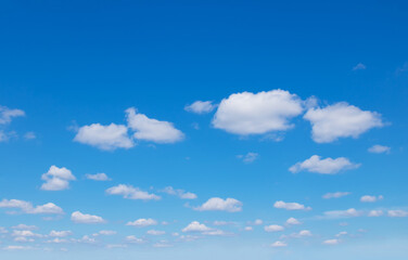 Blue sky background with white fluffy clouds