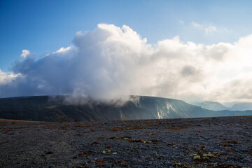 Mountain peaks in the clouds. A chain of gray mountains in the backlight. Khibiny