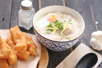 Congee in a Thai-patterned cup and fried dough are Thai food and street food popular to eat in the morning