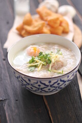 Congee in a Thai-patterned cup and fried dough are Thai food and street food popular to eat in the morning