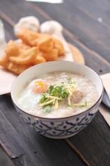 Congee in a Thai-patterned cup and fried dough are Thai food and street food popular to eat in the morning