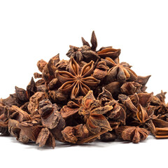 Heap of dried star anise isolated on white background. spot focus.